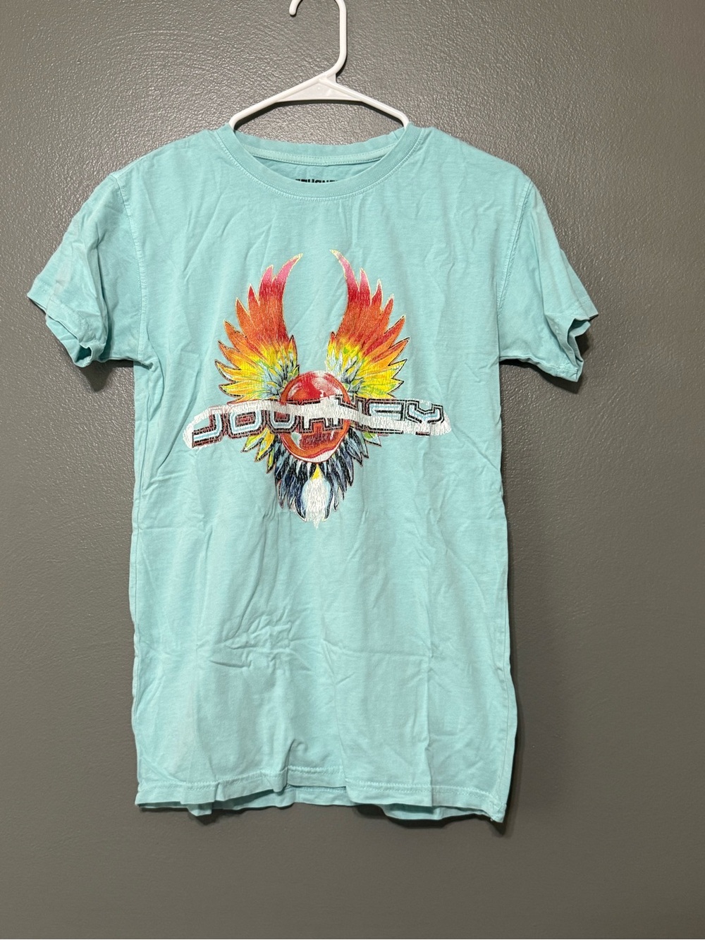 Light Blue Graphic T-Shirt Multicolor Journey Tee wit Winged Emblem.